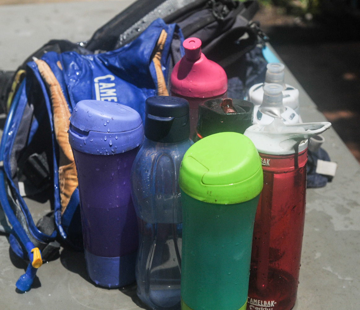 Water Bottle On Tropical Beach. Hydratation And Drinking Regime